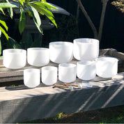 Set of 9 White Crystal Singing Bowls in Beige Bags